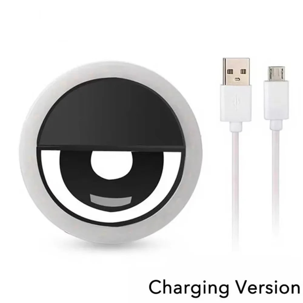 White circular LED clip-on selfie ring light with black center and white USB charging cable.