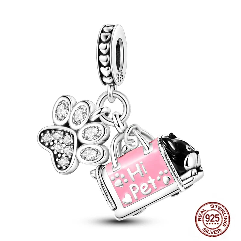 925 sterling silver dog charm with pink pet carrier and crystal paw print for charm bracelets.