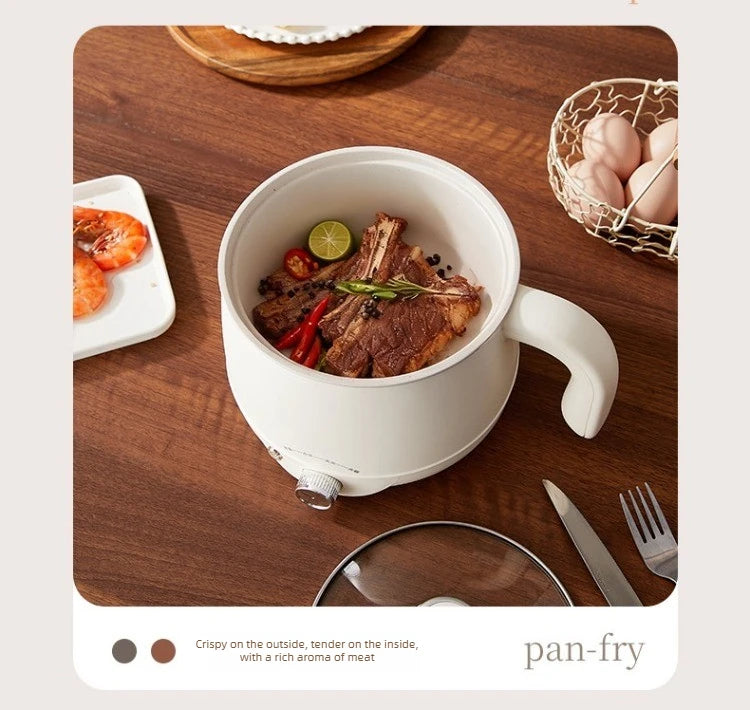 White electric hot pot with steak and vegetables, viewed from above