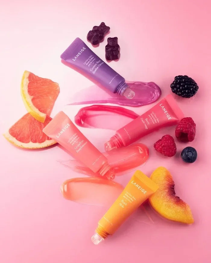 Laneige Lip Glowy Balm set: hydrating, smoothing, and nourishing tinted lip balm tubes with fruit and gummy bear accents.