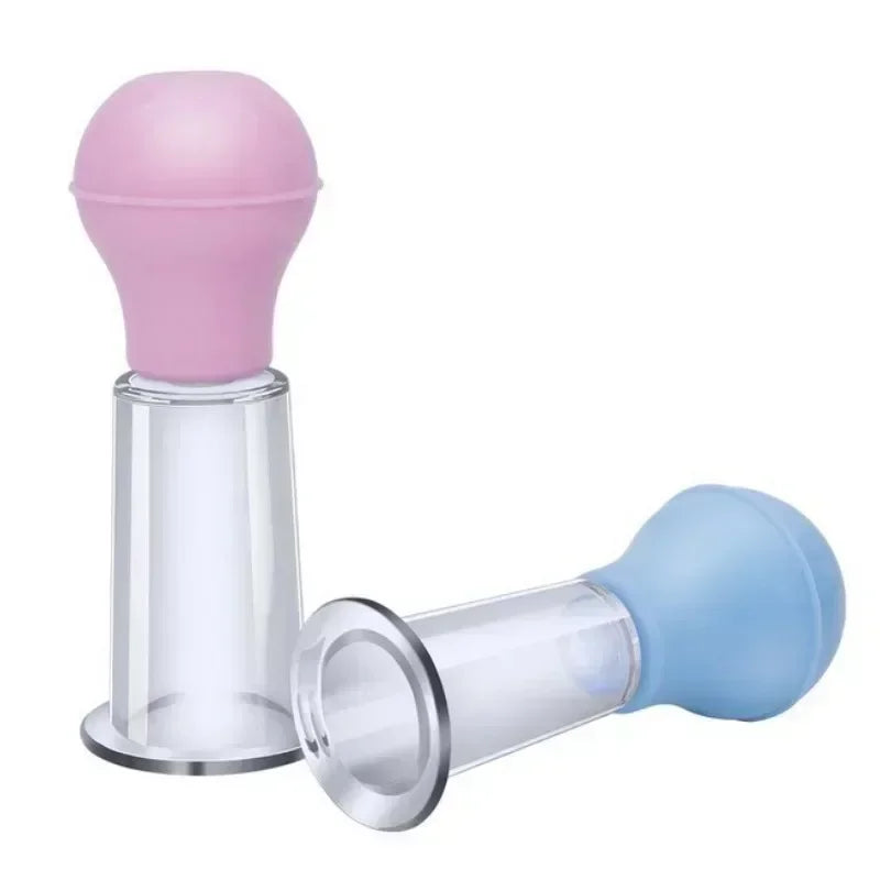 Two facial massage cupping tools with clear plastic cylindrical bases and soft pink and blue rubber squeeze bulbs.