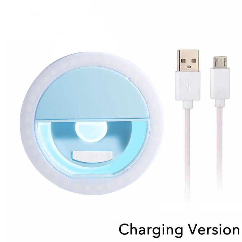 Light blue circular clip-on LED selfie ring light with an included micro-USB charging cable.