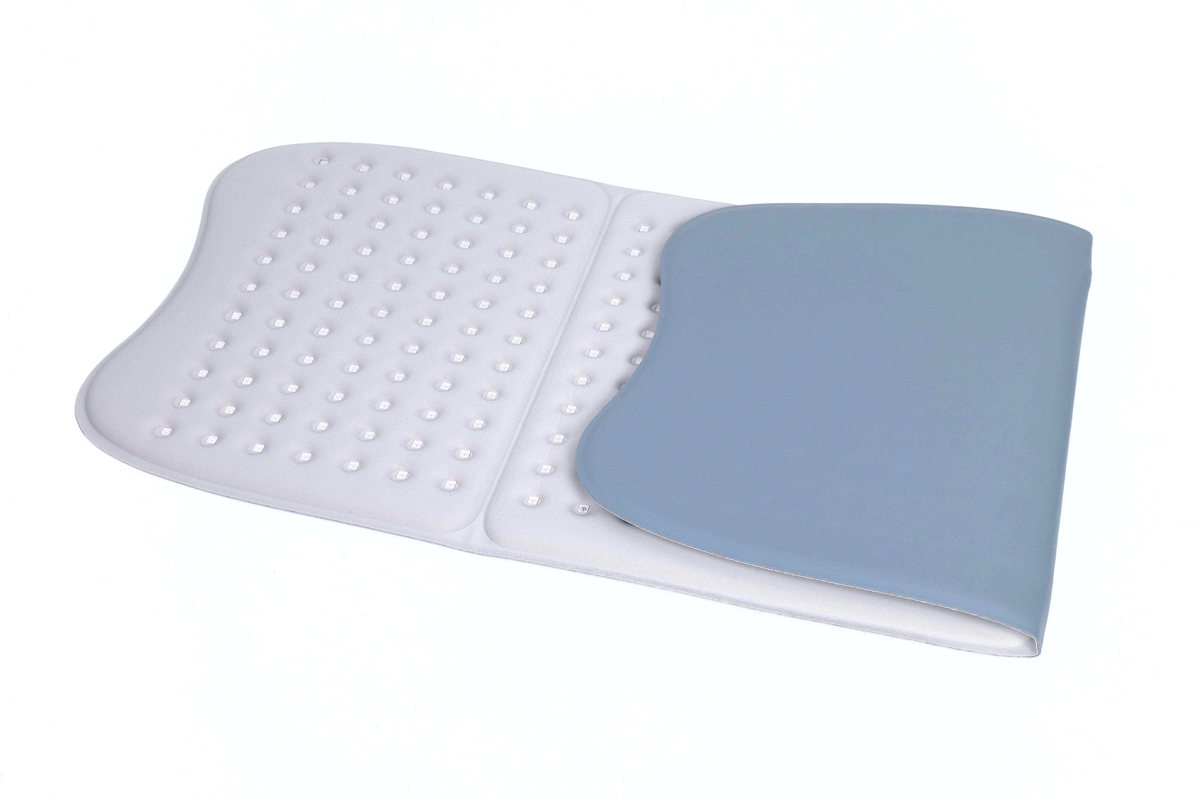 Large rectangular light therapy mat, white with gray backing, featuring an array of embedded LED bulbs.