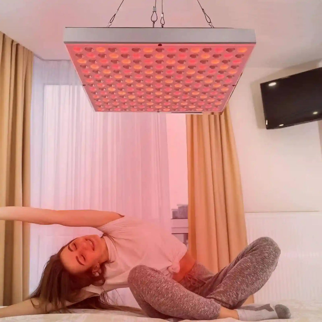 Woman doing yoga under a 45W 660nm/850nm red light therapy panel for home beauty and physiotherapy.