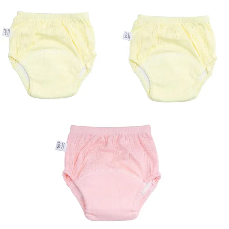 Three-pack of baby cotton training diapers in yellow and pink, breathable baby care essentials.