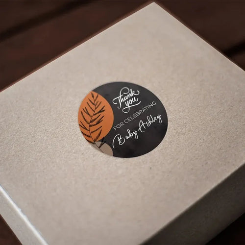 Round thank-you gift sticker on a box with leaf graphic and 'Thank you' message