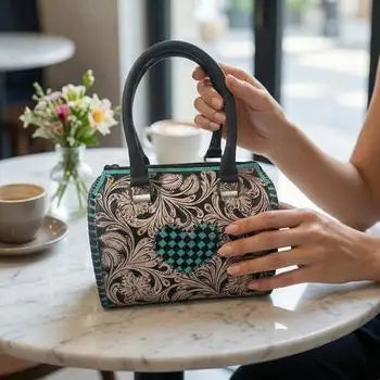 Luxury genuine leather mini trunk duffel with teal floral pattern, black heart inlay, and double handles.