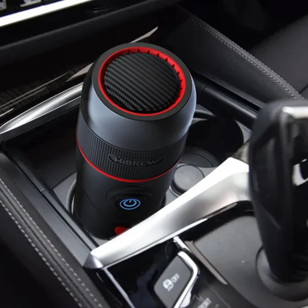 HiBREW portable car espresso coffee maker in black and red, compact design fitting into a vehicle cup holder.