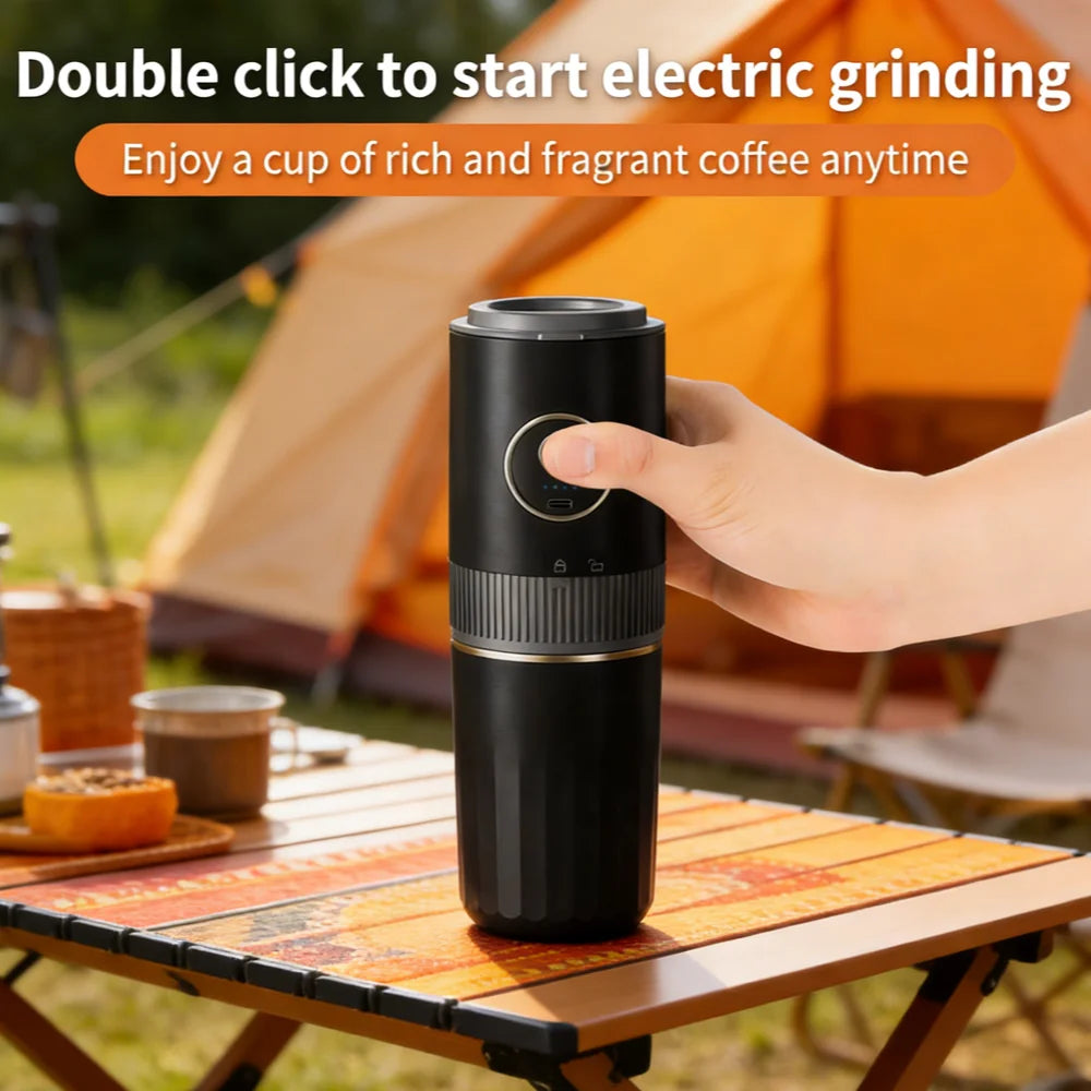 Portable black electric coffee grinder and brewer on a campsite table for outdoor use.