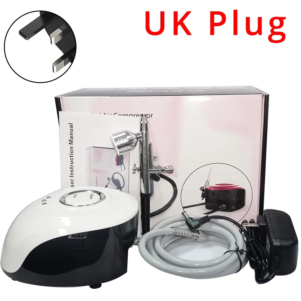 Airbrush kit with a white and black portable compressor, silver spray gun, gray hose, UK power adapter, and manual.