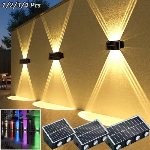 Black rectangular solar wall lights mounted on a wall, casting upward and downward warm beams.