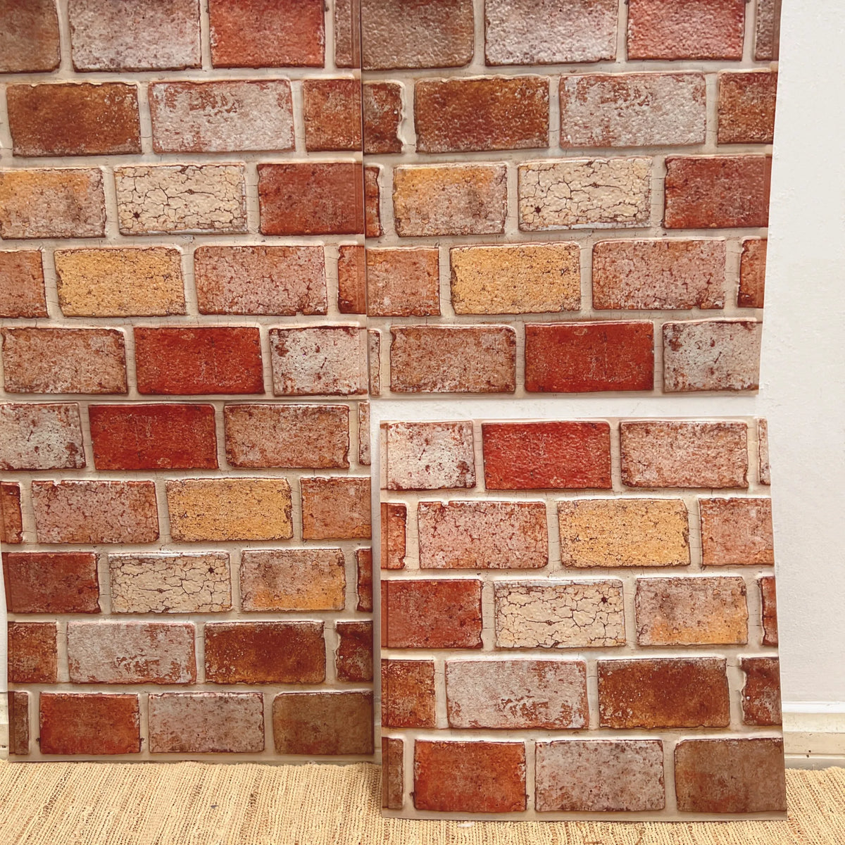 Brick-pattern peel-and-stick backsplash tiles with red, tan, and cream tones (12 in x 12 in).