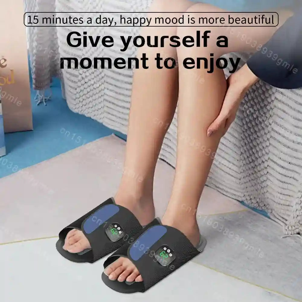 Black EMS electric foot massager slippers with digital display for muscle stimulation and circulation relief.