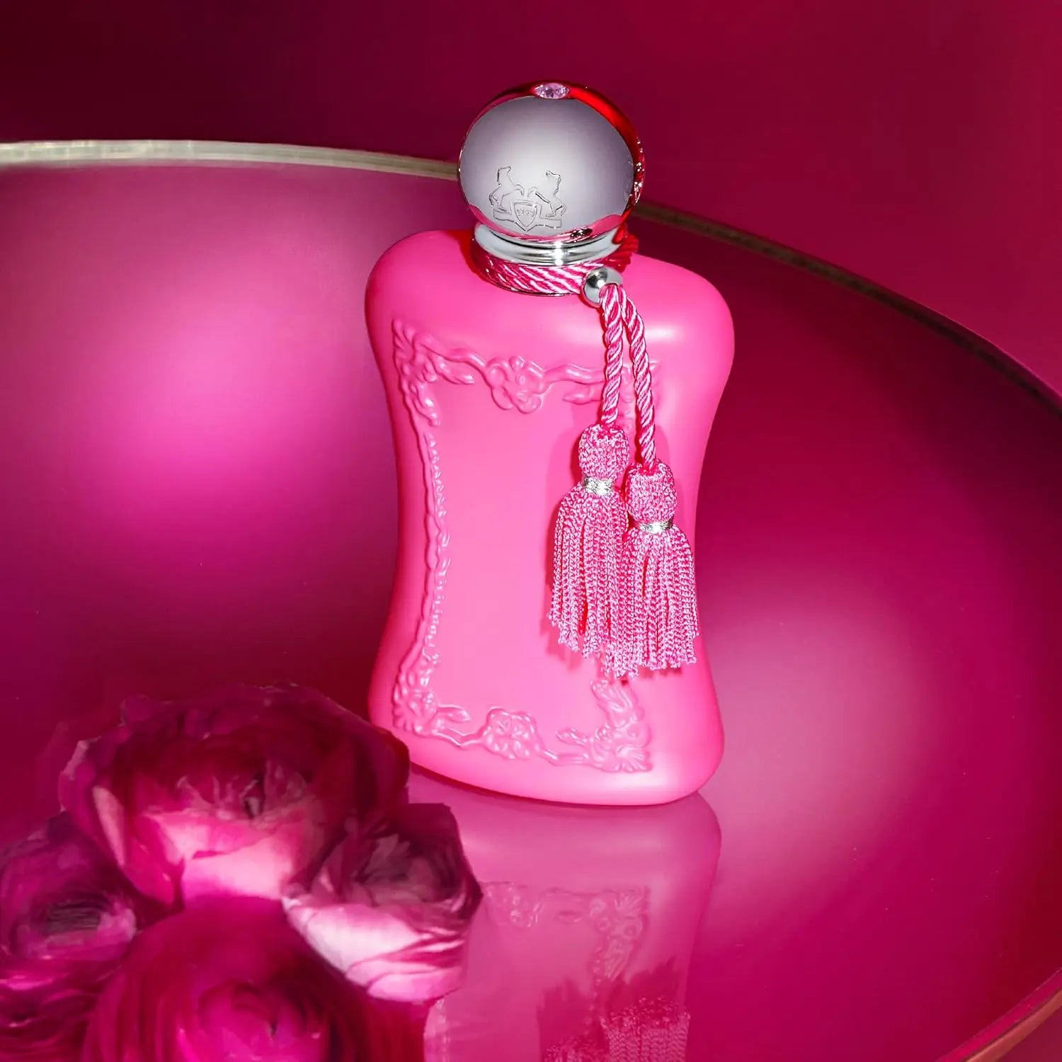 Parfums de Marly Delina Eau de Parfum for women: pink floral bottle with tassels on a vibrant magenta background.