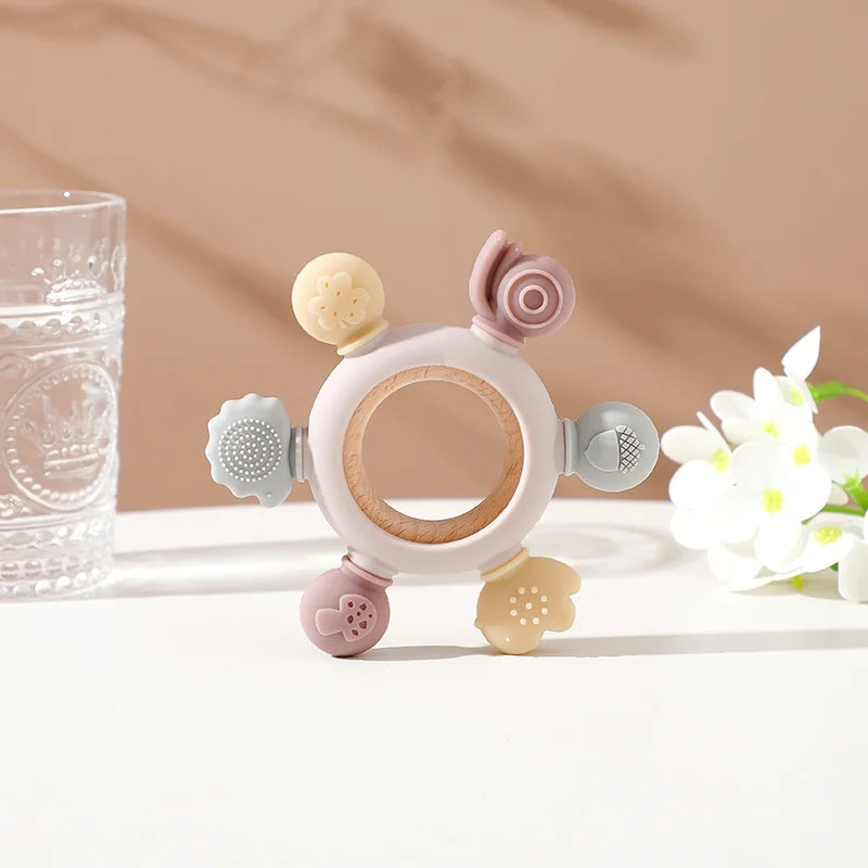 Multicolor silicone and wood teething ring toy for baby relief.