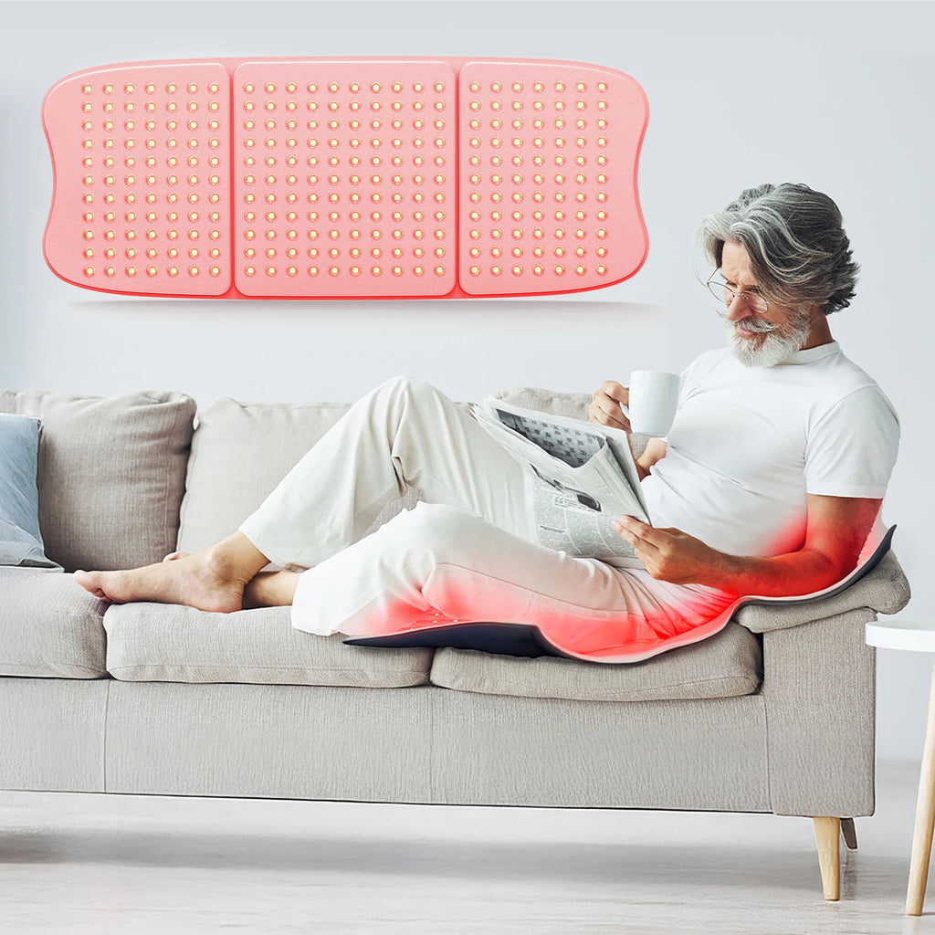 Man uses Hello Face L7 red light therapy pad with 792 LED chips, 660nm and 850nm wavelengths, on a couch.