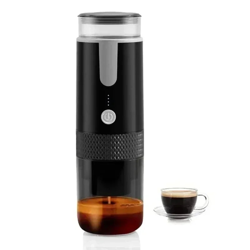 Portable black electric espresso maker with clear base and power button, next to a small glass cup of brewed coffee.