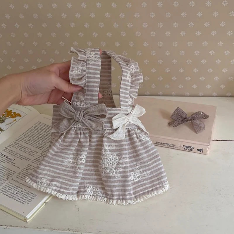 Cute striped dog dress with bows and floral embroidery for small to medium pets. Stylish spring puppy summer outfit.
