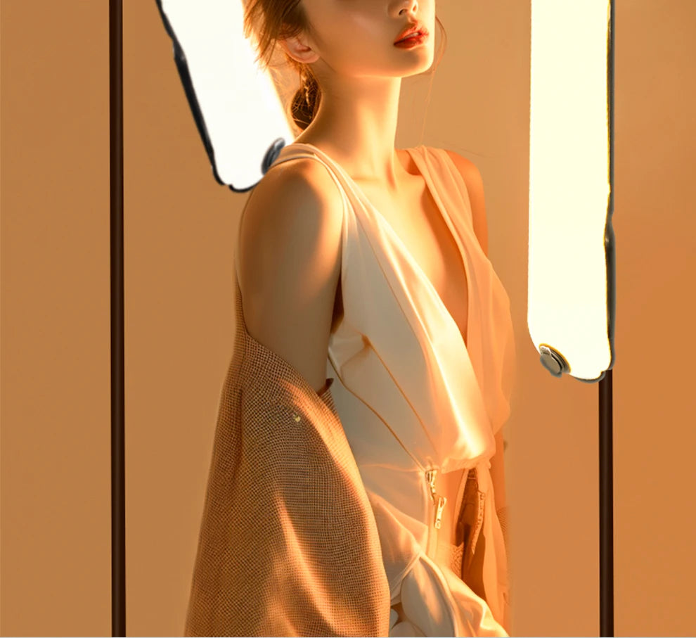 Tall, rectangular LED floor lamp with soft white light panels on thin black stands, used for professional photography.