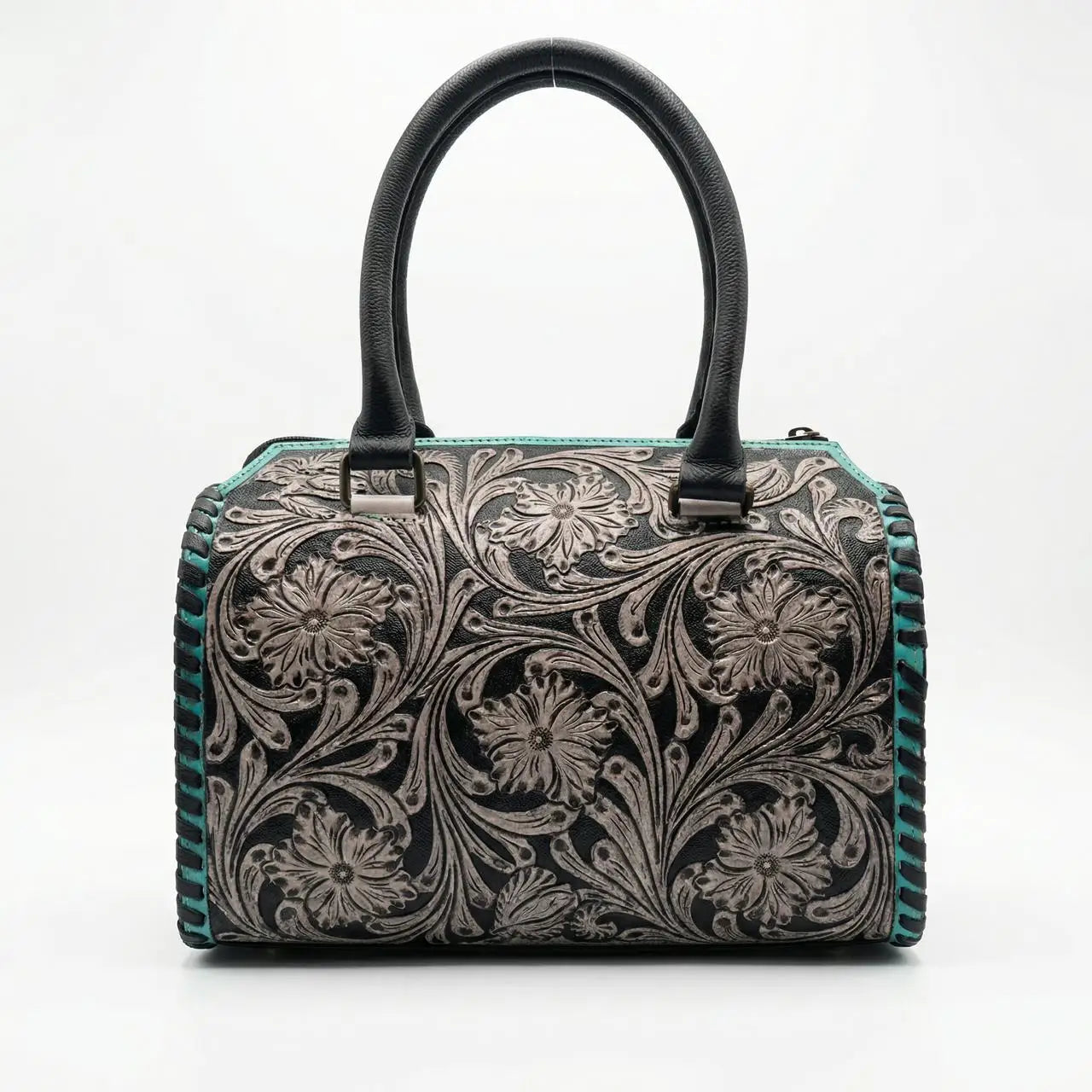 Luxury black leather mini duffel trunk with teal floral tooling, double handles, and whipstitch trim.