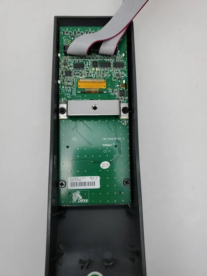 Zebra ZT230 printer control panel interior with green circuit board and cable