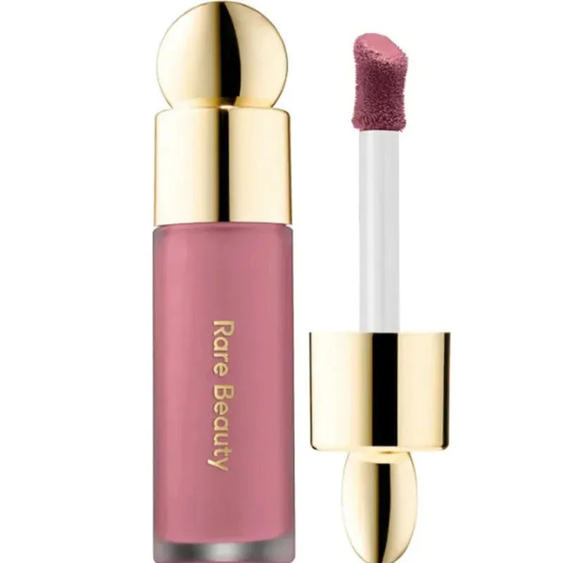 Rose liquid blush and lip stain in a sleek bottle with a gold cap and soft-touch applicator wand.