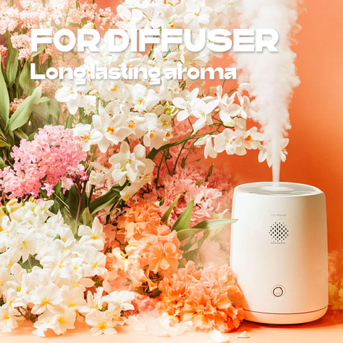 White aromatherapy diffuser emitting mist amidst floral orchids for wellness and relaxation.