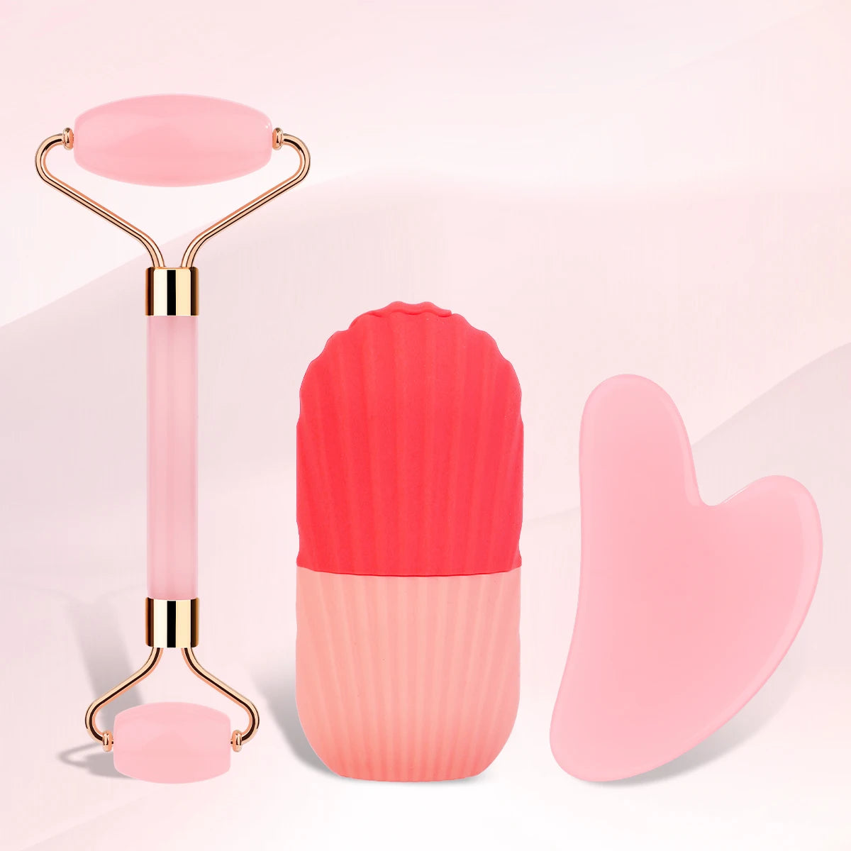 A 3-piece facial massage set featuring a pink jade roller, a two-tone silicone ice roller, and a heart-shaped gua sha.