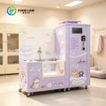 Self service dog wash machine in pastel purple with cloud backdrop, tub, and cute animal graphics on wheels.