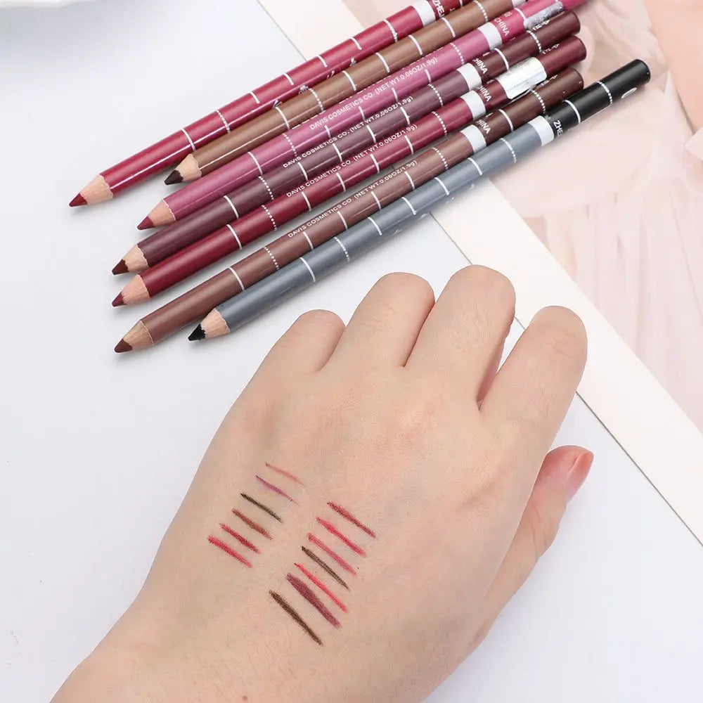 Professional waterproof wood lip liner pencils in assorted shades with hand swatches showing rich, smooth pigment.