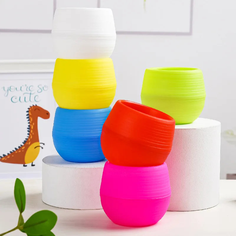 Assorted mini plastic flower pots in yellow, green, blue, orange, and pink