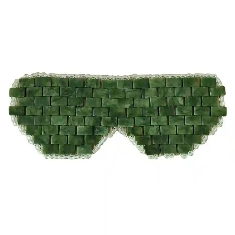 Natural green jade stone eye mask for cooling spa therapy, facial massage, and relaxation sleep aid on white background.