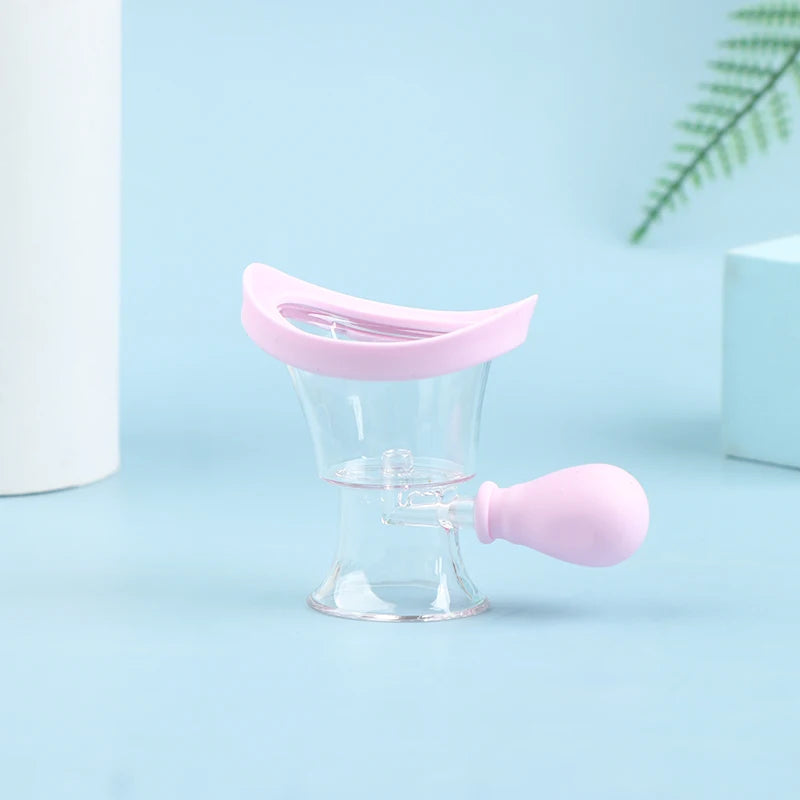 Reusable silicone eye wash cup with pink rim and squeeze bulb for gentle eye flushing and rinsing.