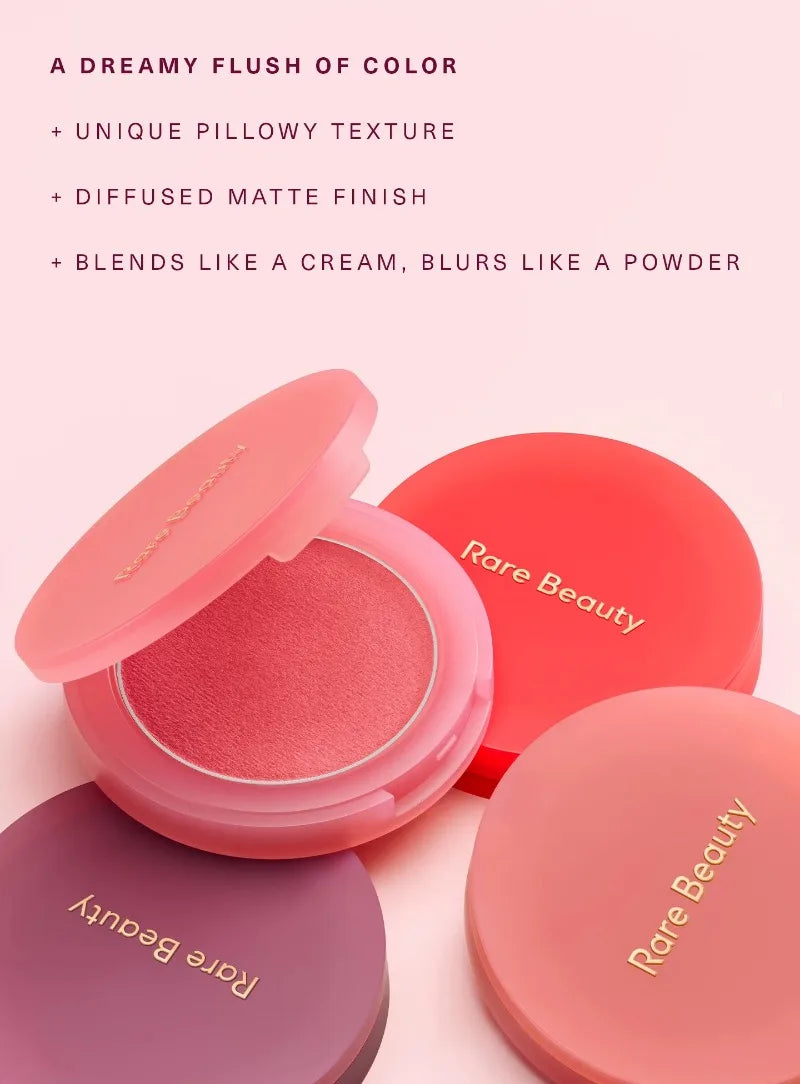 Rare Beauty powder blush with pillowy matte texture in pink, coral, and berry compacts for a soft, diffused flush.