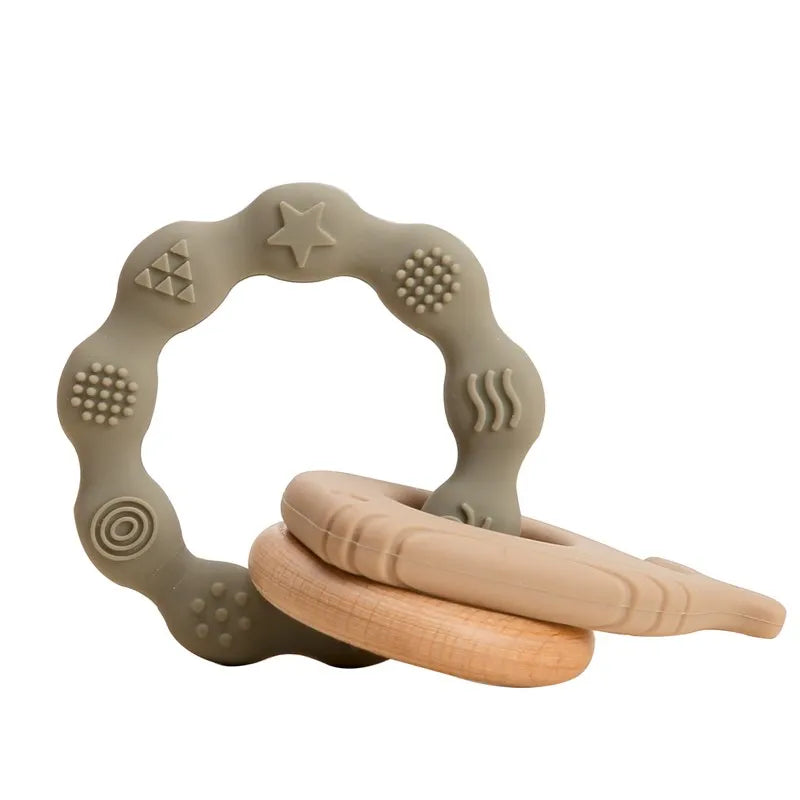 Beige and olive silicone teething ring toy with natural wood for baby teething relief.