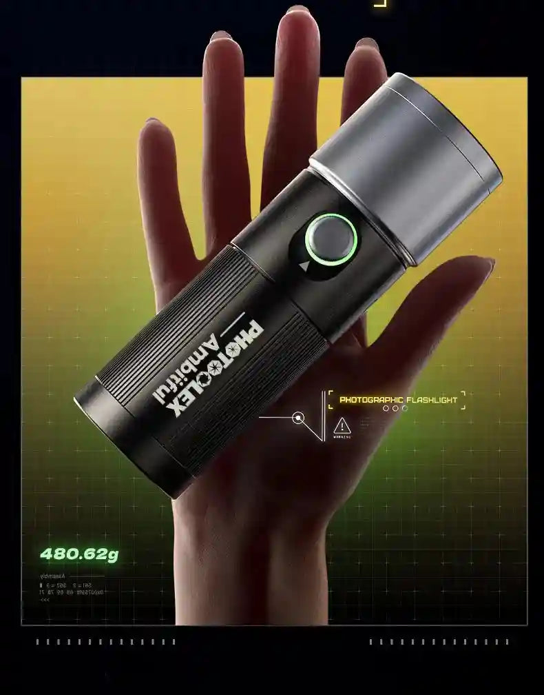 Compact black and silver metal photographic flashlight held in a hand, featuring a round power button with green light.