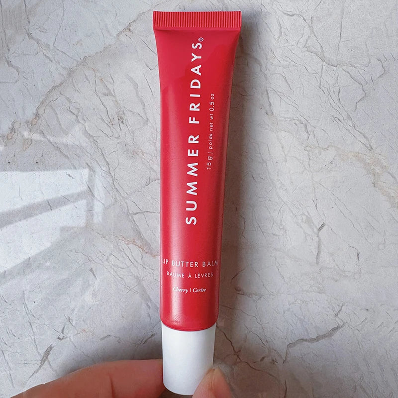 Summer Fridays Lip Butter Balm in Cherry. Red squeeze tube packaging for moisturizing, glossy, soft lip makeup.