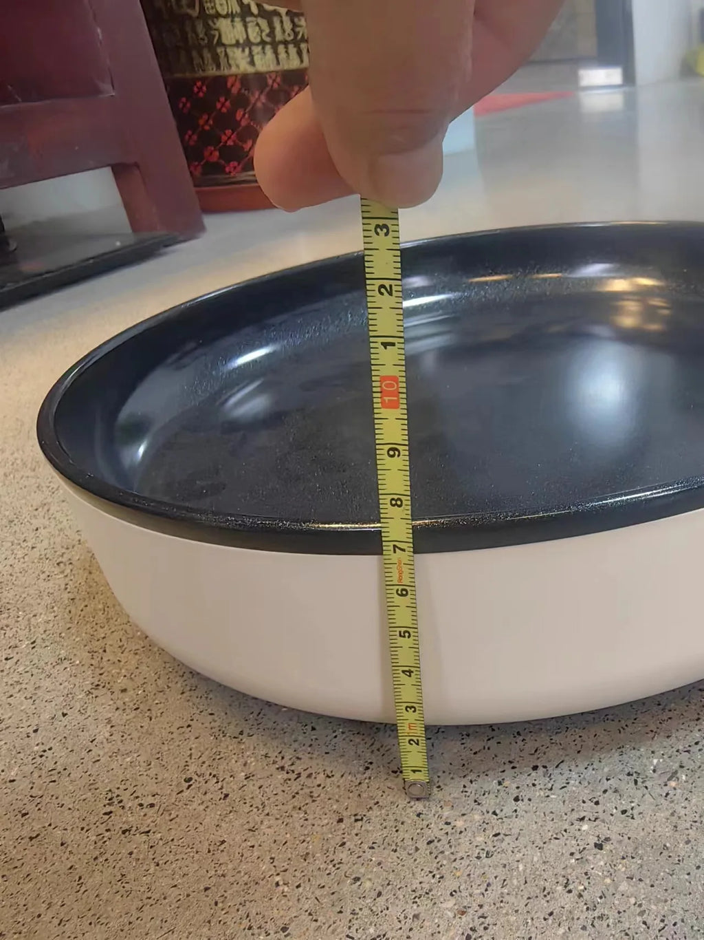 Electric frying pan, black nonstick cooking surface, white body, measured with ruler