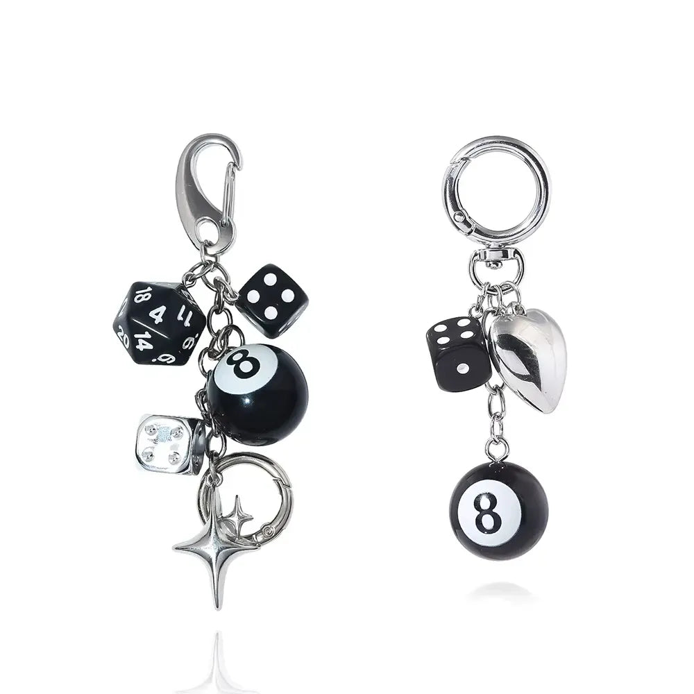 Silver-tone keychain set with 8-ball charm, star pendant, black dice and silver die