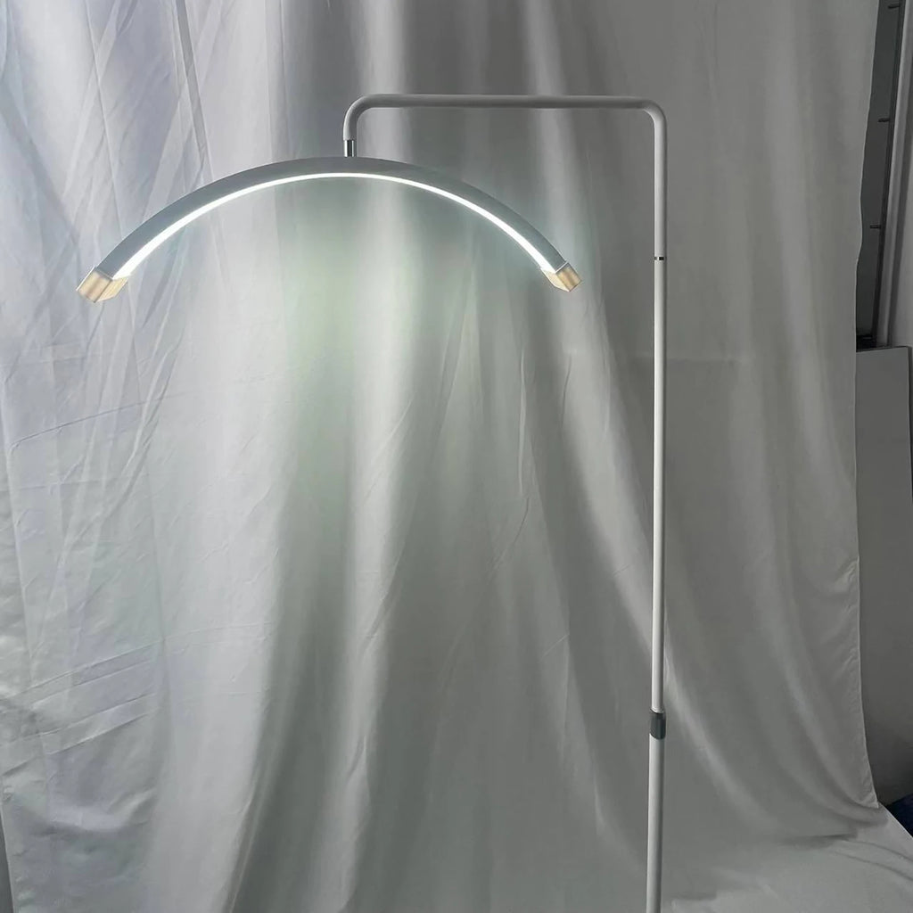 White arched LED floor lamp with a thin metal frame and adjustable light for focused task illumination.