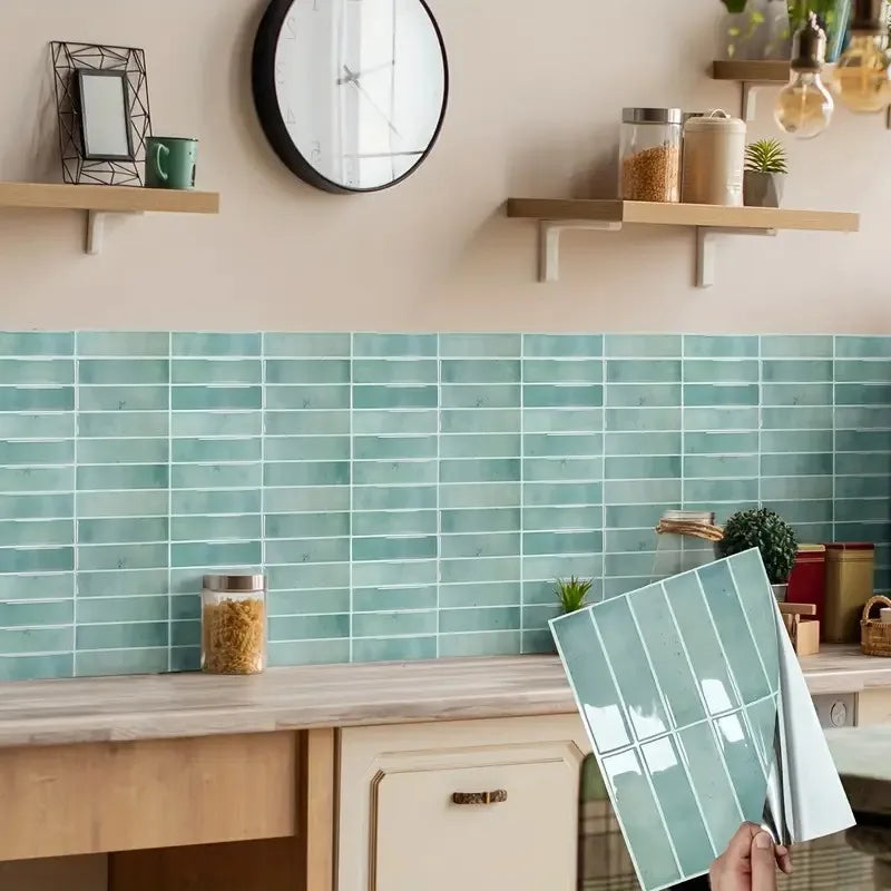 Light aqua peel-and-stick backsplash tile sheet with glossy subway tile pattern, held for installation
