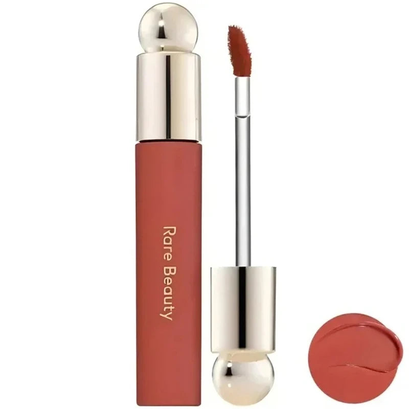 Rare Beauty Soft Pinch Tinted Lip Oil with applicator and glossy swatch, featuring a moisturized, long-lasting finish.