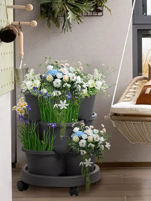 Three stacked dark planters on a round wheeled base for vertical growing