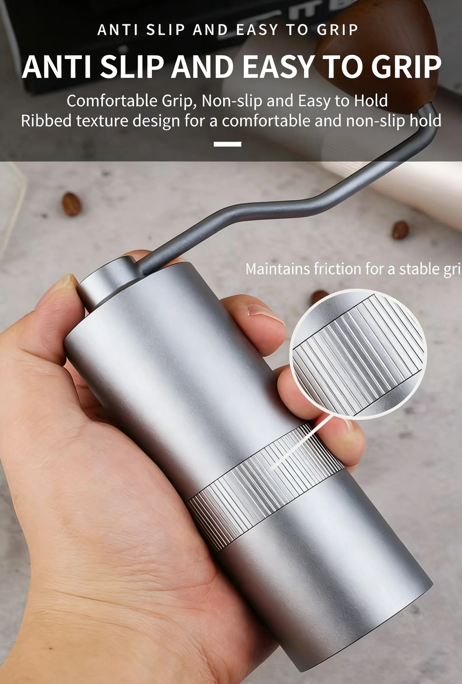 Handheld manual coffee grinder in silver metal with a ribbed, non-slip grip and wooden handle knob.