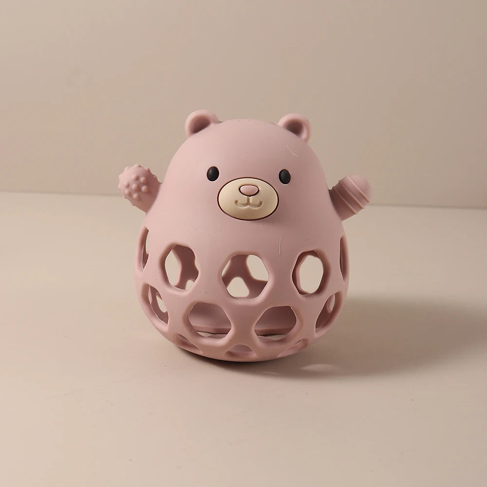 Pink silicone baby teething toy bear with honeycombed design for infant teething relief.