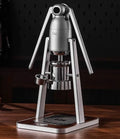 Bincoo manual lever espresso maker in silver metal with wood base on a dark background.