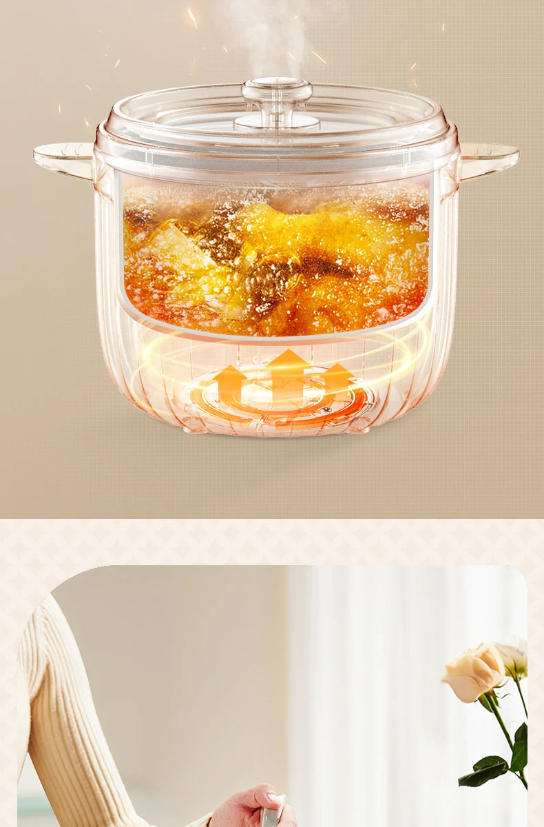 White electric rice cooker with transparent lid and steam rising from food