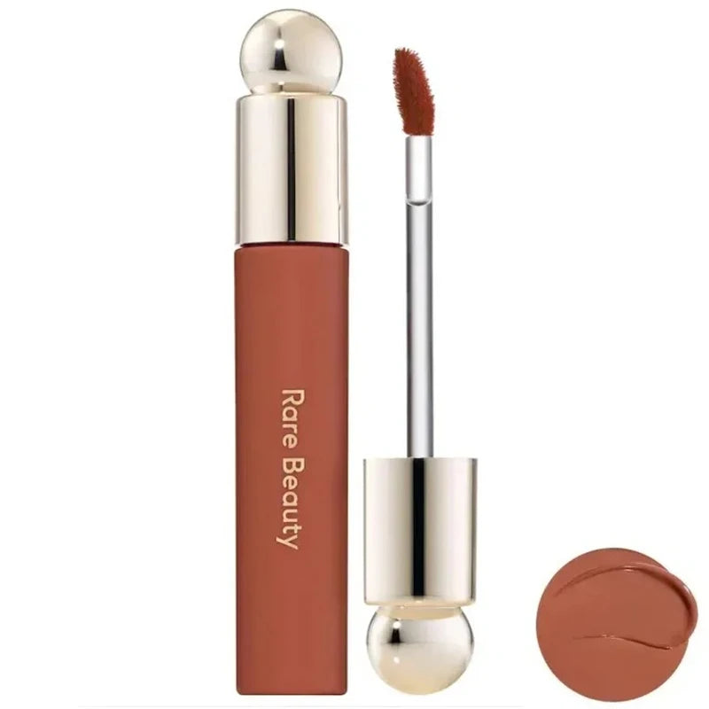 Rare Beauty Soft Pinch Tinted Lip Oil with applicator wand and rich brown-toned pigment swatch.