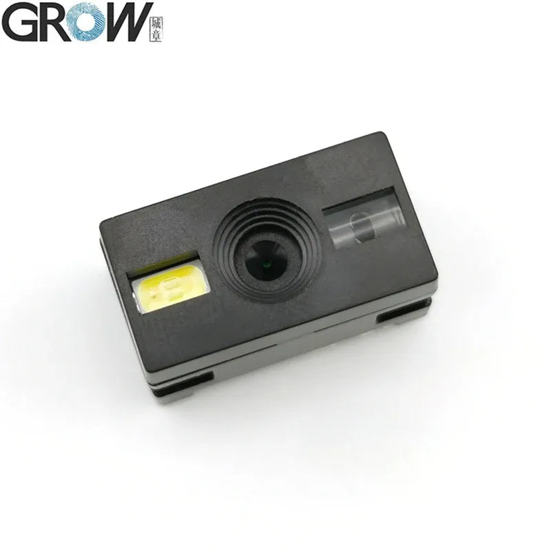 Dark gray barcode scanner module with front lens window and small yellow status label
