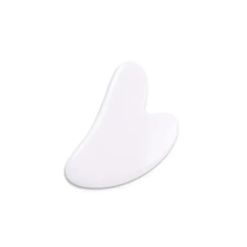 White heart-shaped resin Gua Sha facial massage tool for skin lifting, wrinkle reduction, and face sculpting.